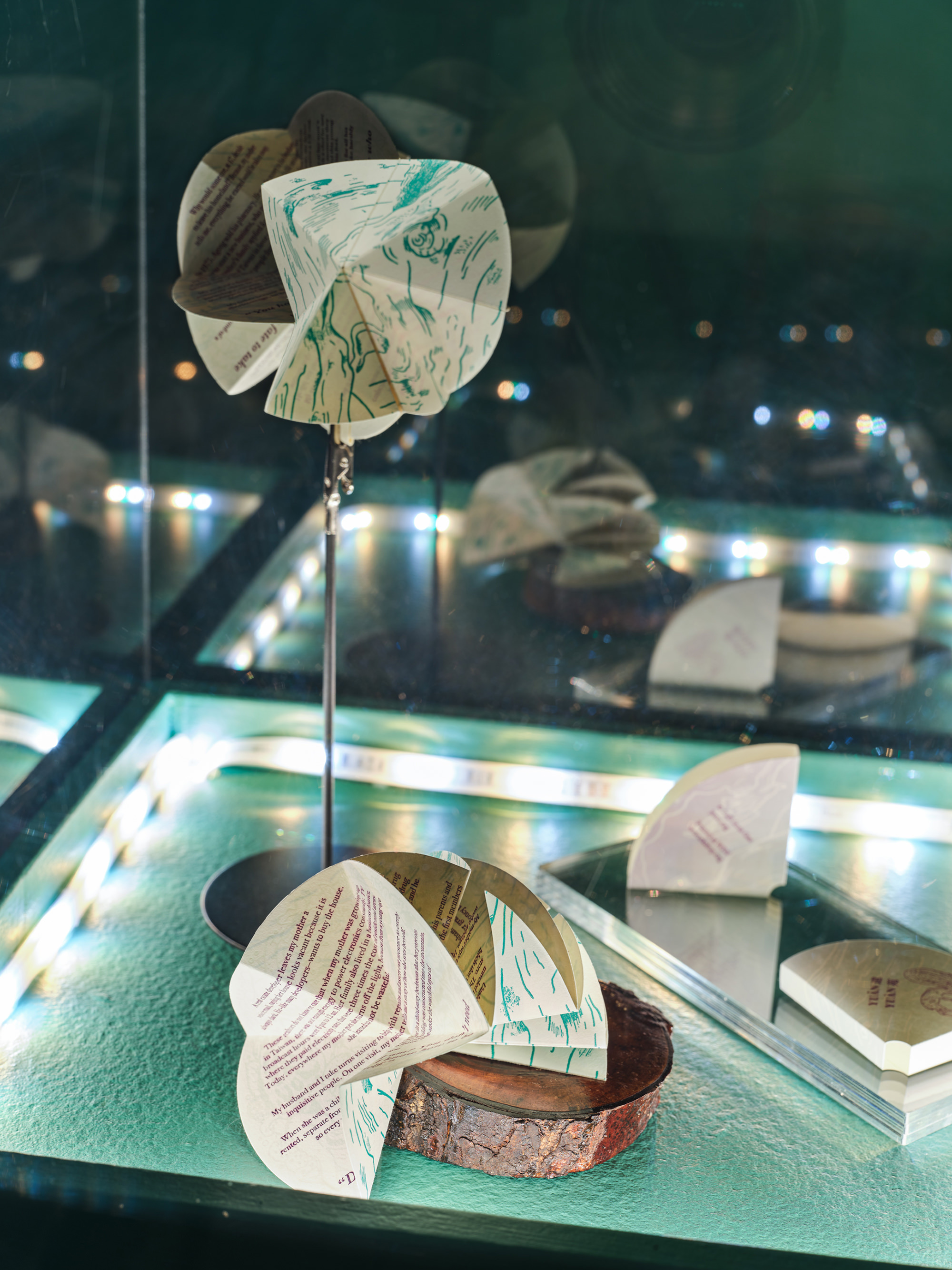 Gao holding artist's book, opening one page spread to a full circle