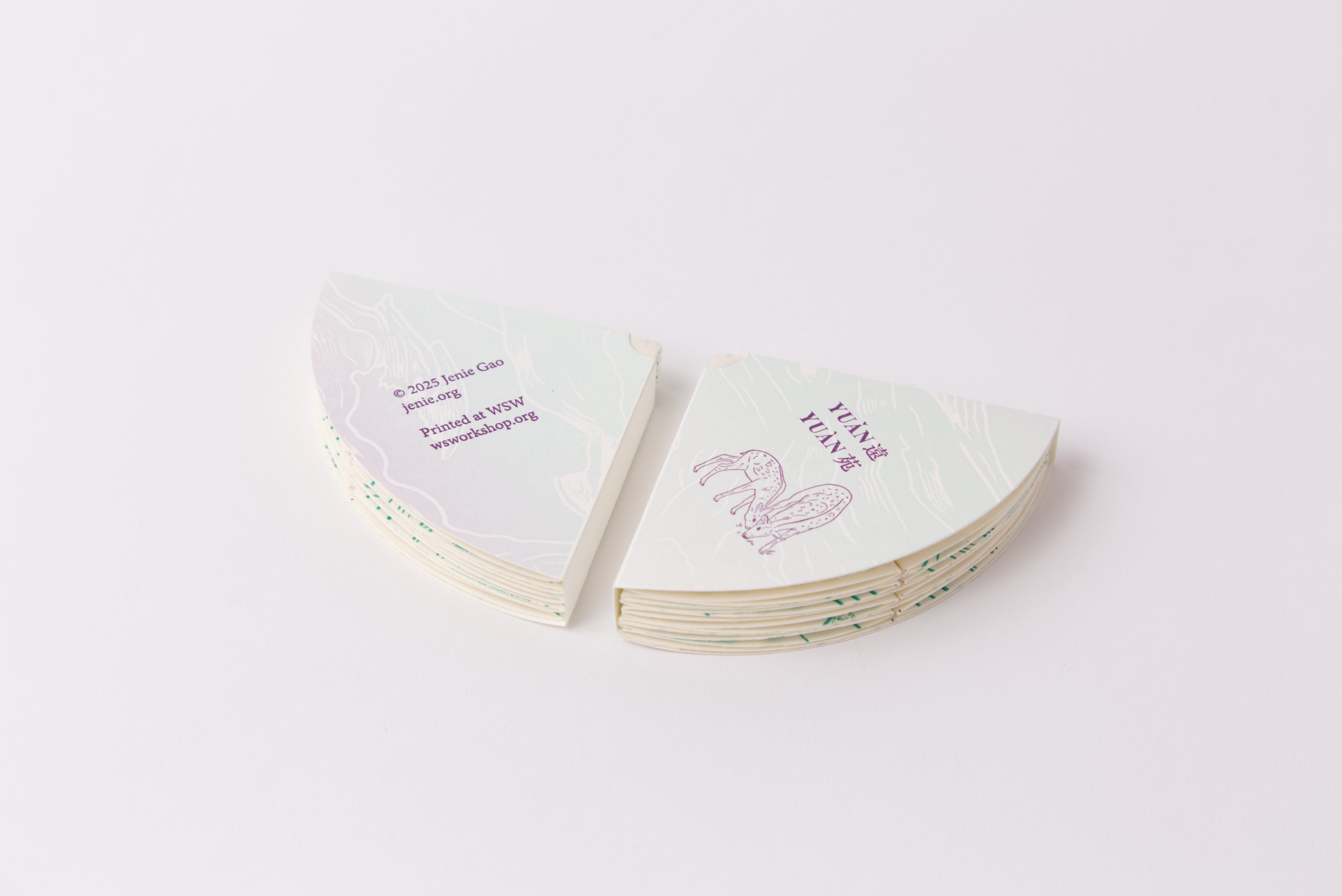 Cover sleeve for artist's book, printed in pale jade and lavender with an image of two deer grazing in deep violet
